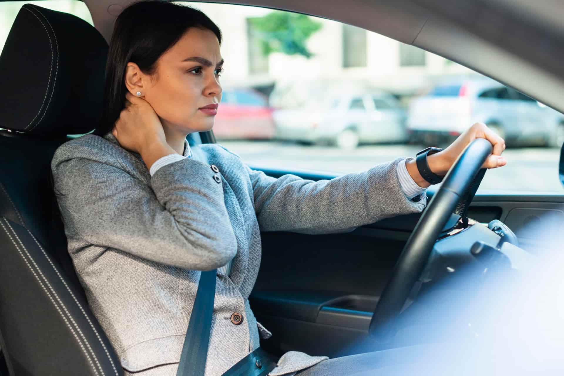 Female holding her neck in pain from whiplash and auto accident injury