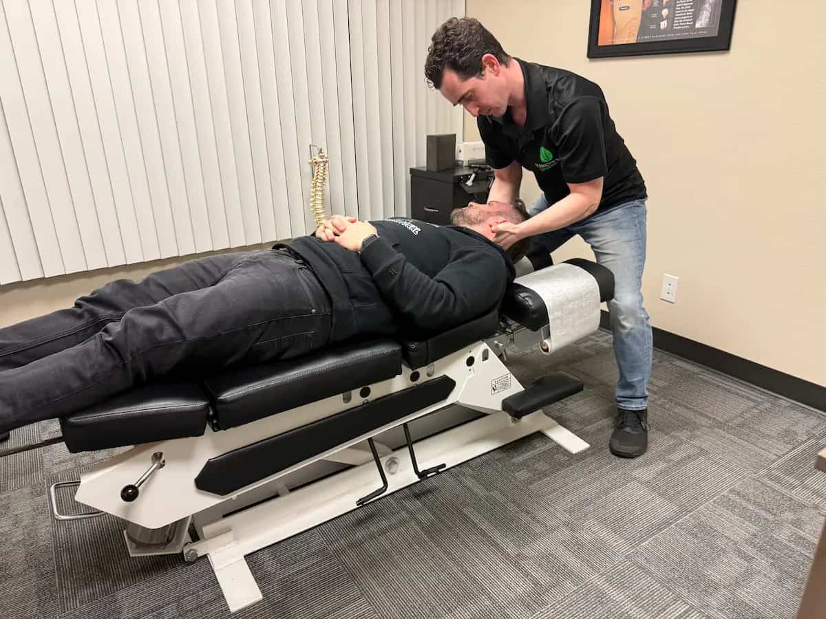 Chiropractor performing neck cracking adjustment