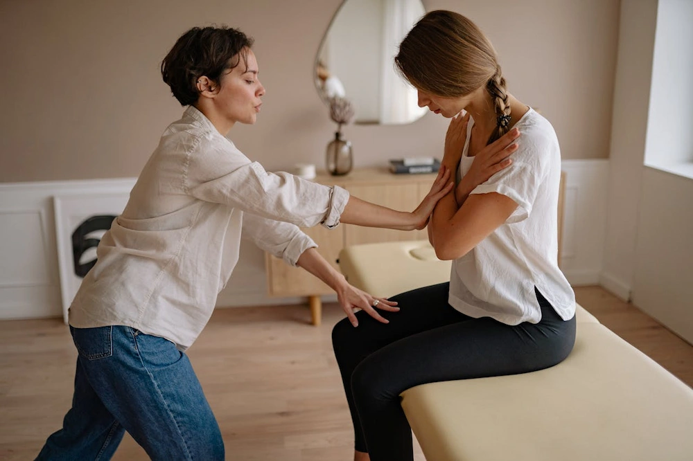 female chiropractor examining patient in clinic