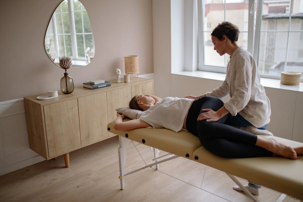 female chiropractor assessing woman back pain